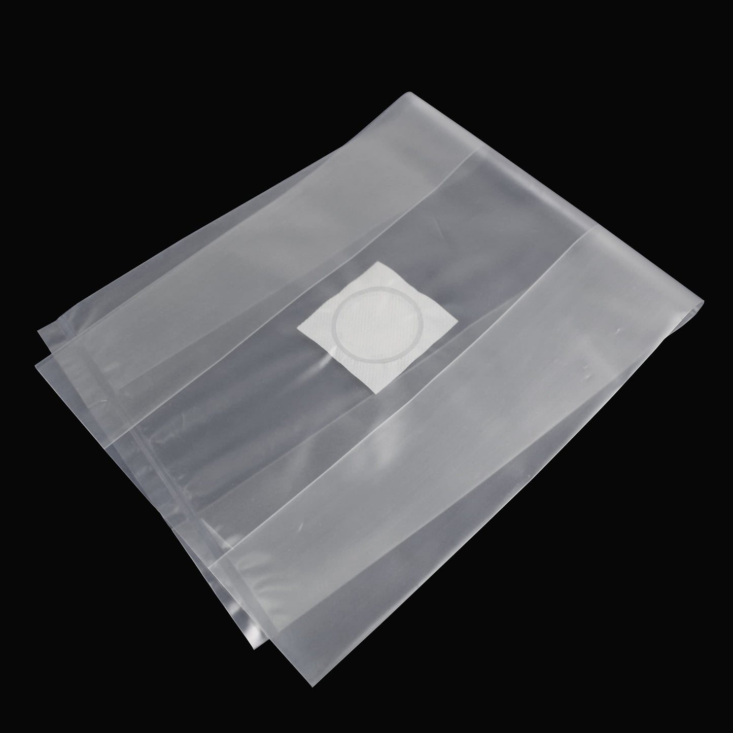 Clear plastic bag with a white filter inside on a black background