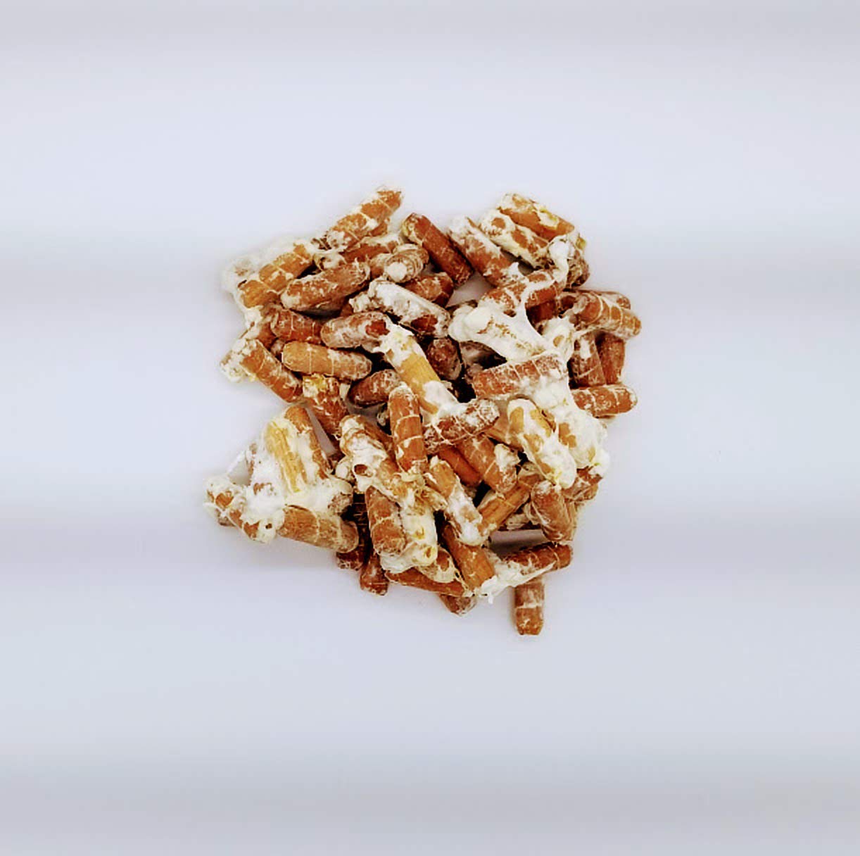 Pretzel sticks with white chocolate drizzle on a white background