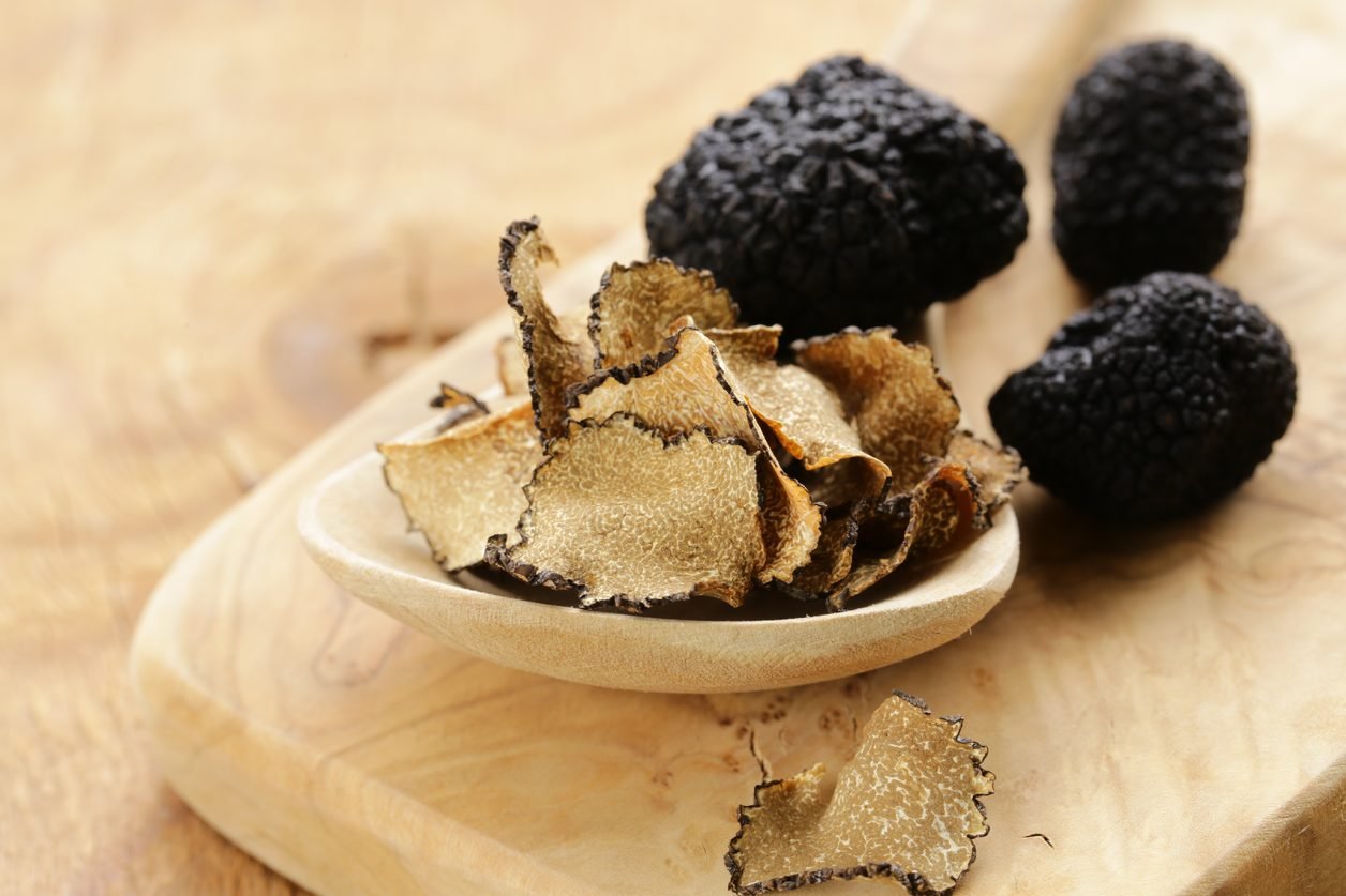 Dried black truffles on a wooden board