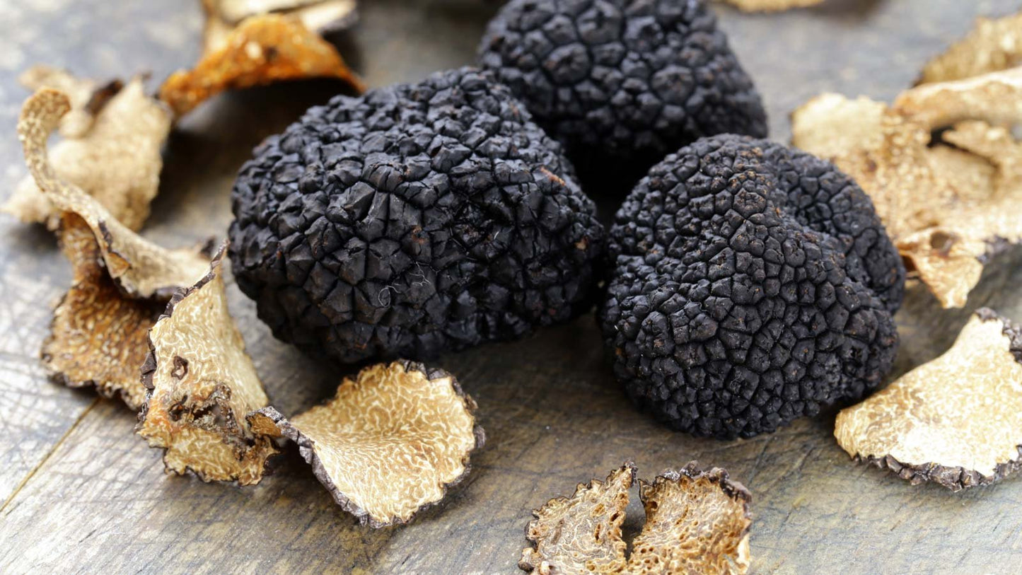 Black truffles on a wooden surface