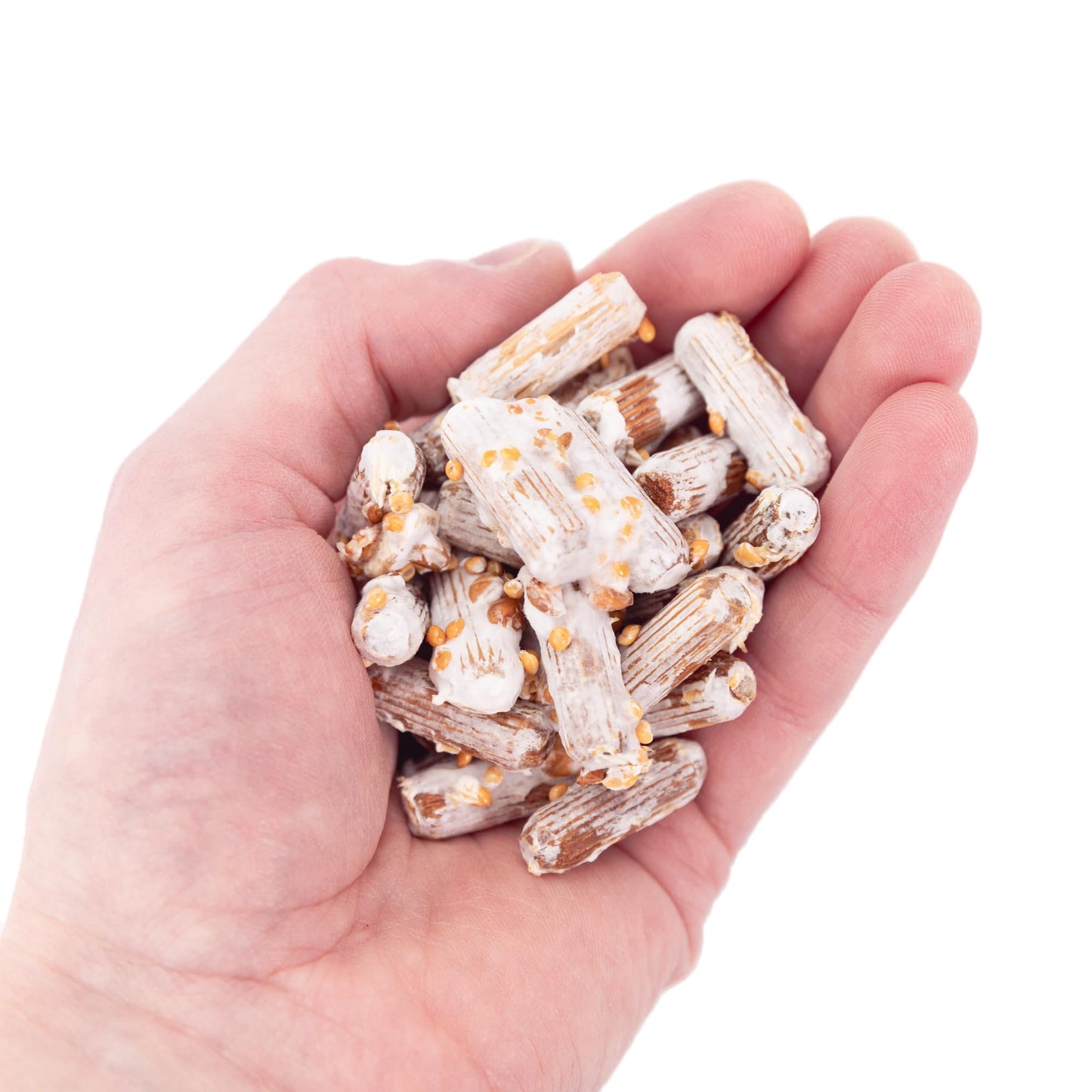 Hand holding a small pile of white and brown snack sticks on a white background