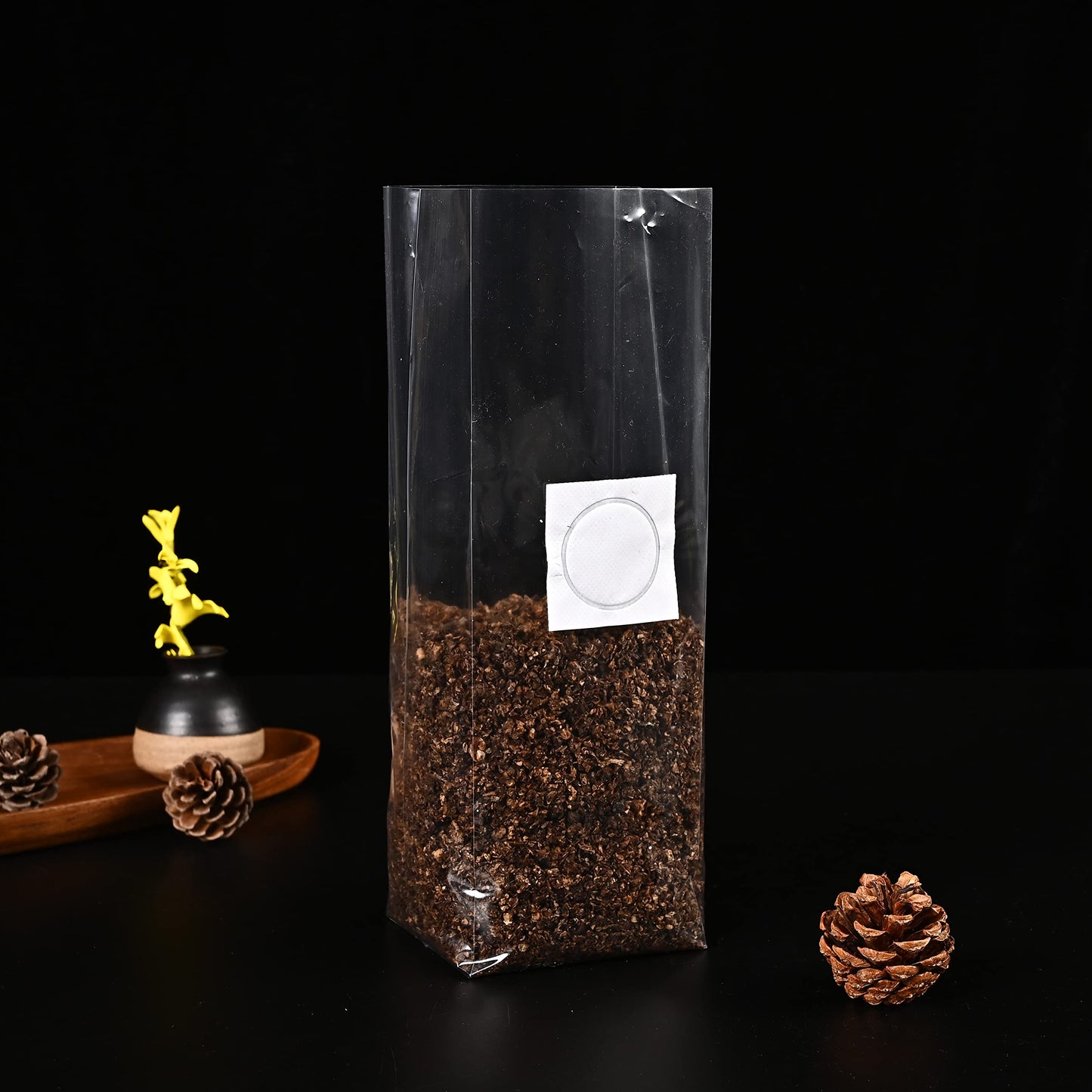 Clear plastic bag with compost and a label on a dark background