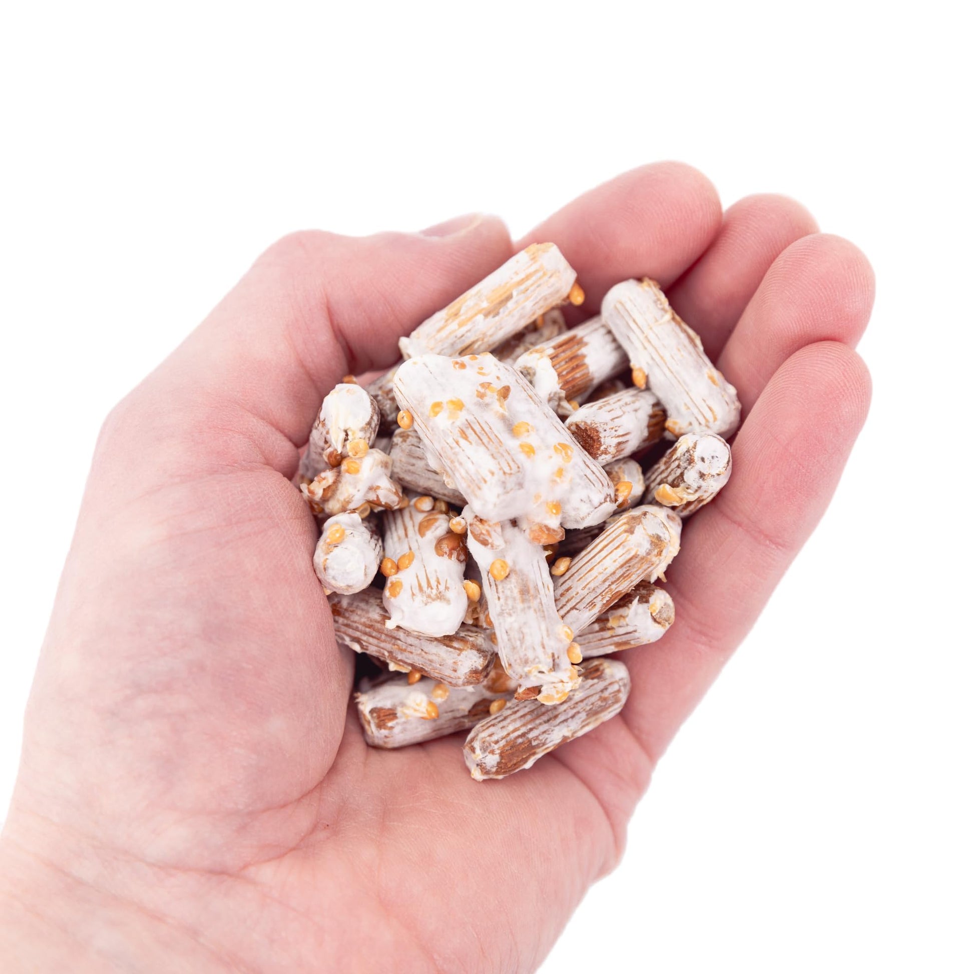 Hand holding a small pile of white and brown snack sticks on a white background