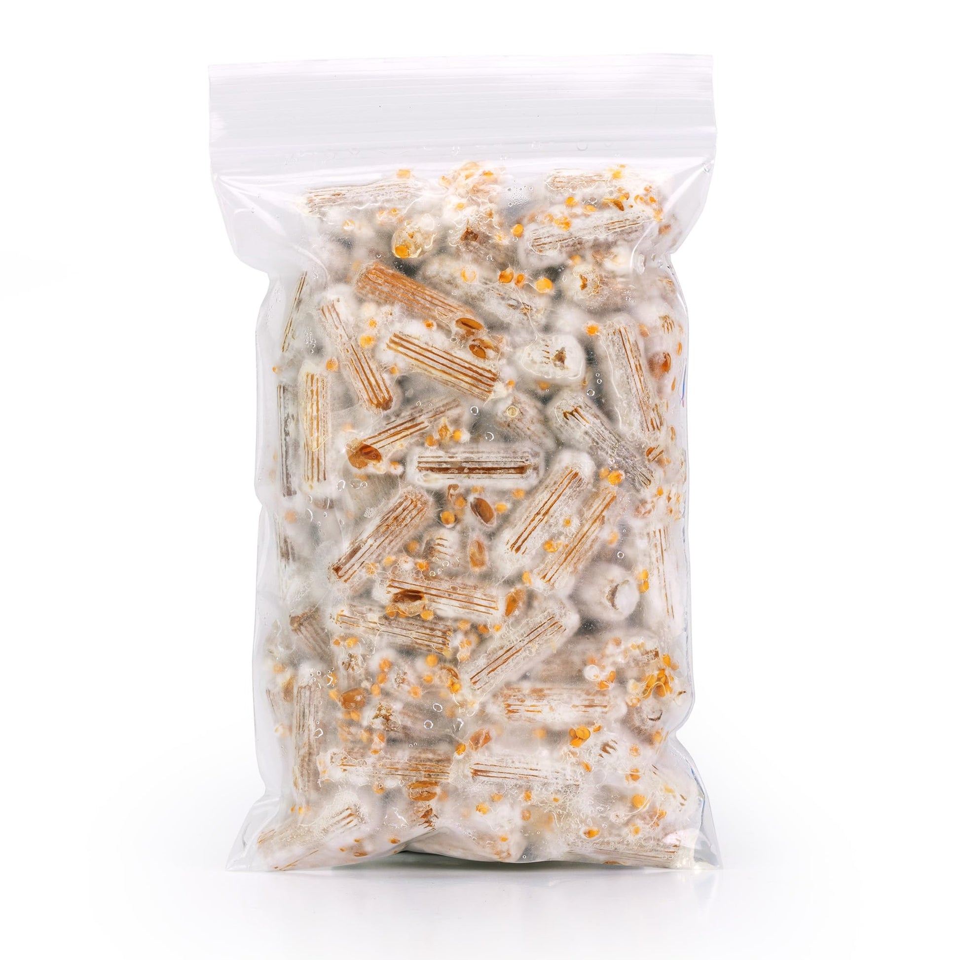 Clear plastic packaging filled with mushroom plugs on a white background