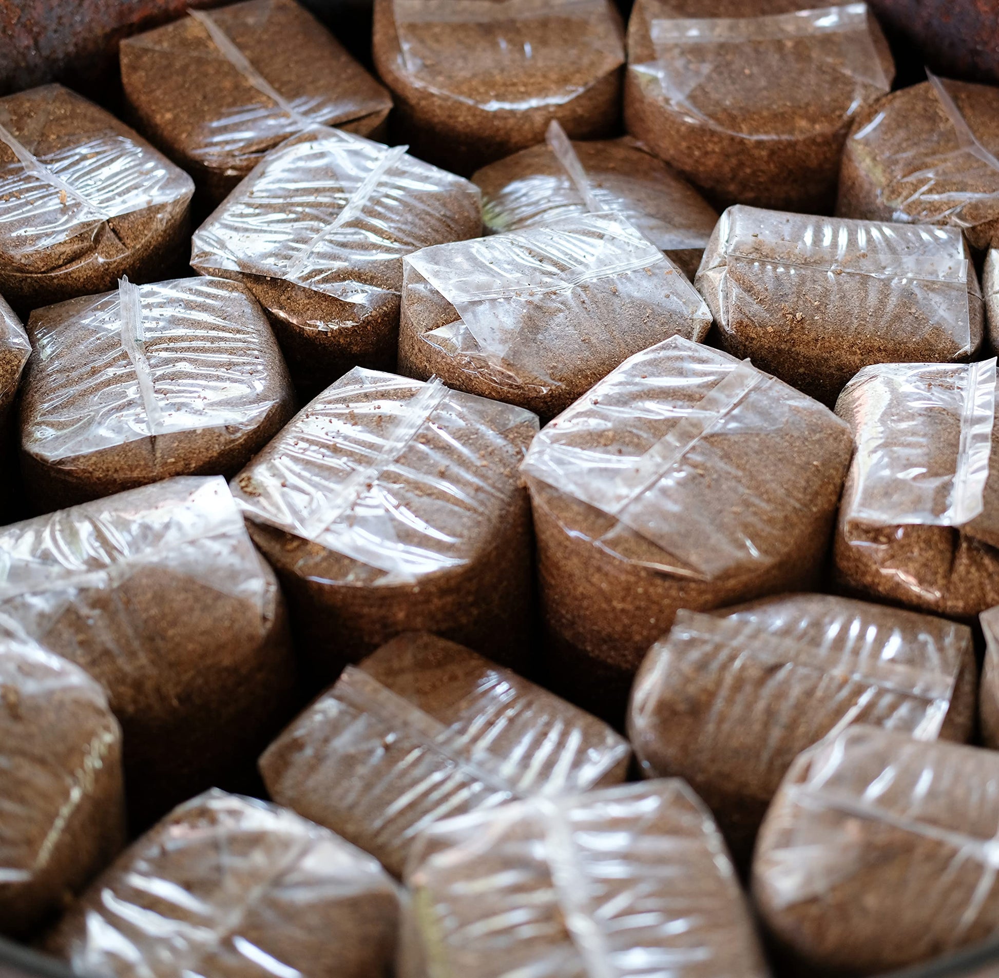 Bundles of brown material wrapped in clear plastic
